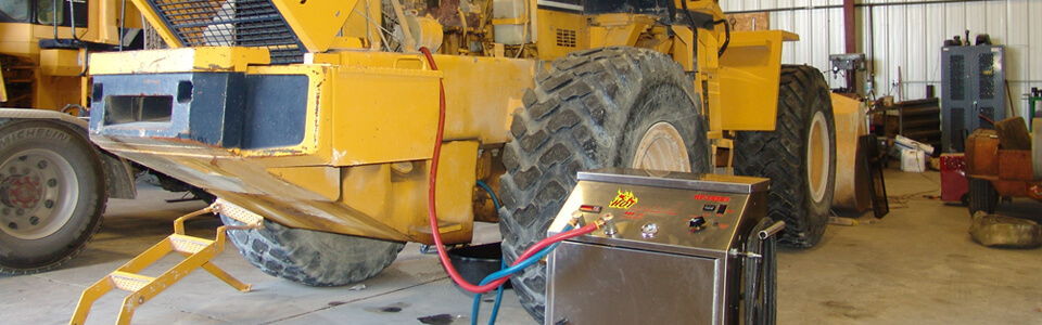 The Hot Flush macine cleaning the cooling device on a construction vehicle.