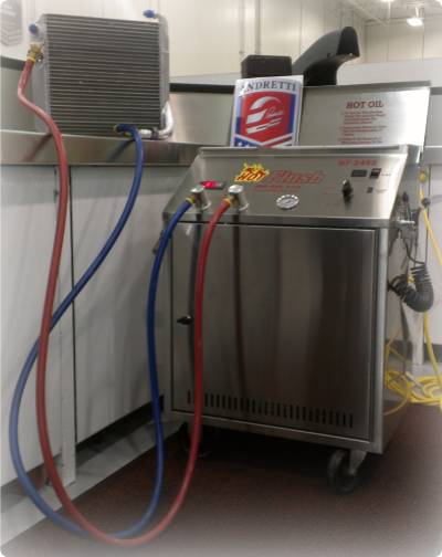 A picture of the Hot Flush machine being used to clean a cooling device.